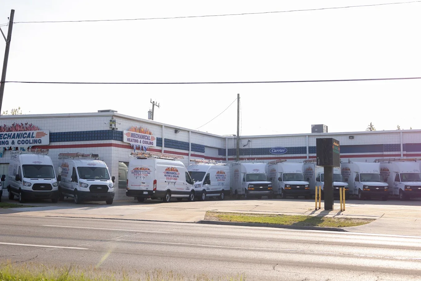 Mechanical Heating, Cooling & Electrical fleet lined up outside the company building